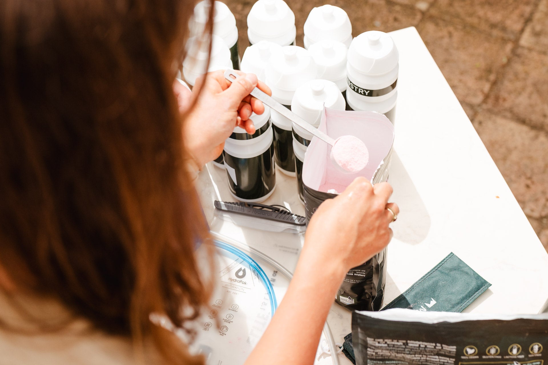 Athletin befüllt Trinkflaschen mit einem Drink Mix